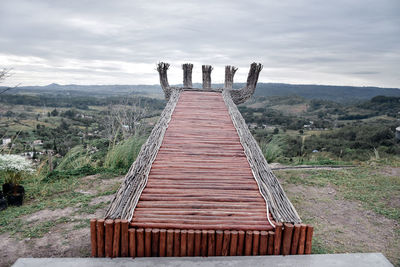 Gazebo on landscape against sky