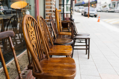 Antique wooden chairs outside shop