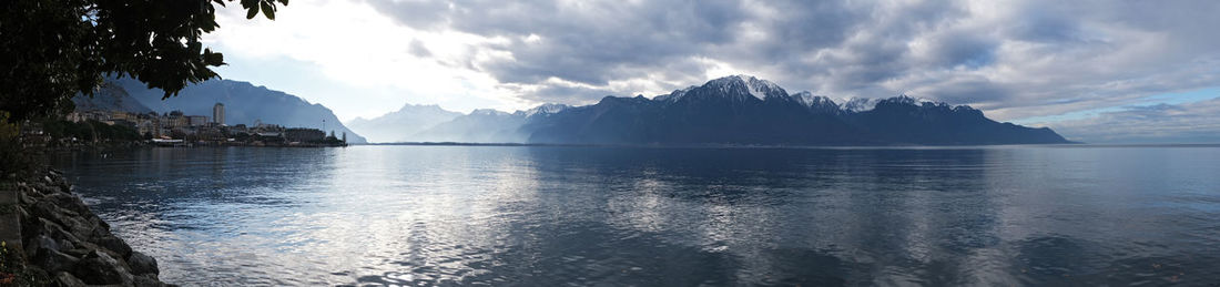 Panoramic view of sea and mountains against sky