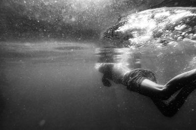 Close-up of swimming men in lake 