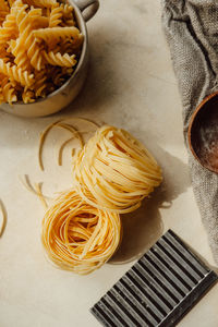 Raw tortiglioni pasta on background in cup. process of making hand-made pasta from durum wheat