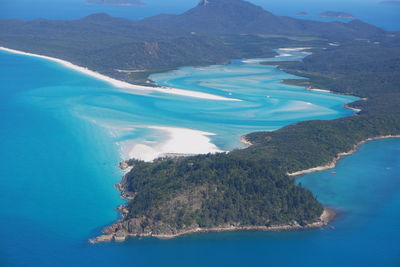 High angle view of sea and mountains against sky