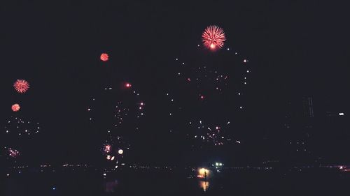 Low angle view of firework display at night