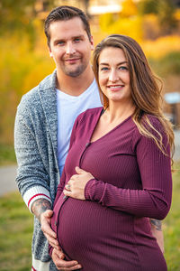 Young pregnant couple in autumn park