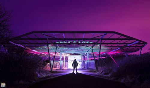 Illuminated tunnel at night
