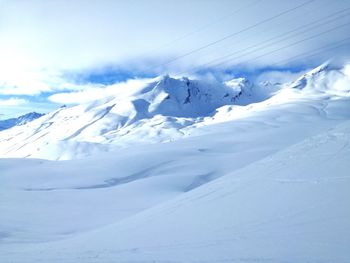 Scenic view of snow covered mountains against sky