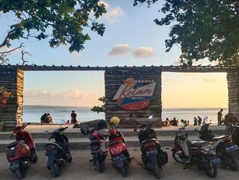 People on street against sky during sunset