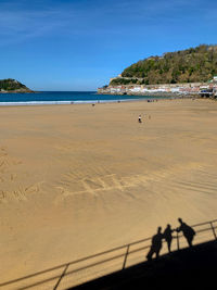 People on beach against sky