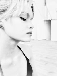Close-up portrait of young woman looking away