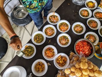 High angle view of man preparing food on table