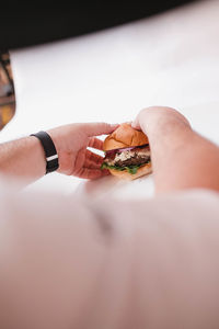 Close-up of hand holding ice cream in plate