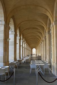 Empty chairs and table in corridor