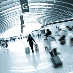 Blurred motion of people walking in airport