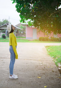 Rear view of man standing on footpath