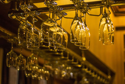 Upside down view of wineglasses on table in illuminated restaurant