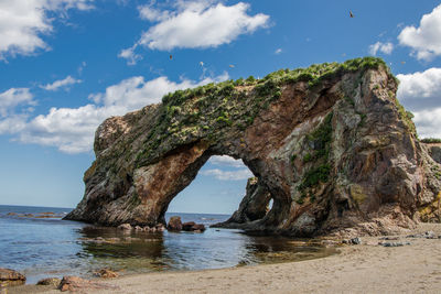 A stone natural arch, on the coast of the sea of okhotsk. cape velikan, sakhalin island, russia.