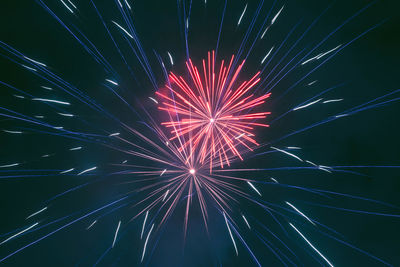 Low angle view of firework display at night