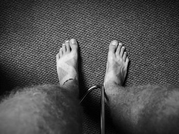 Low section of man relaxing on floor