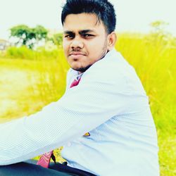 Portrait of young man on field