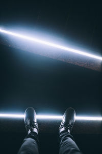 Low section of man wearing shoes