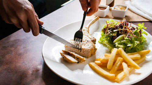 Cropped hand of person preparing food