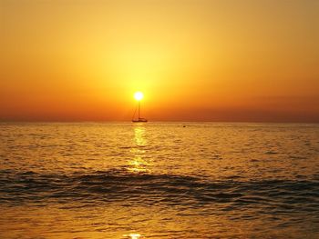 Scenic view of sea against orange sky