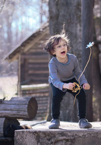 Portrait of boy holding wood