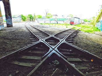 Railroad tracks in city against clear sky