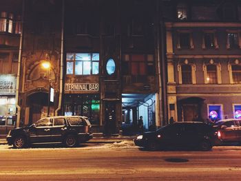 Cars in illuminated city at night