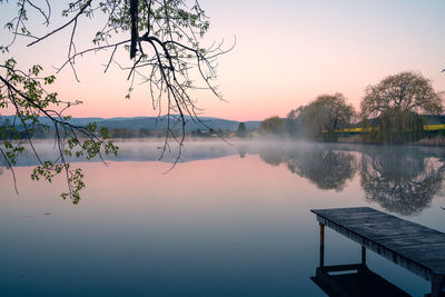 Scenic view of lake against sky during sunset