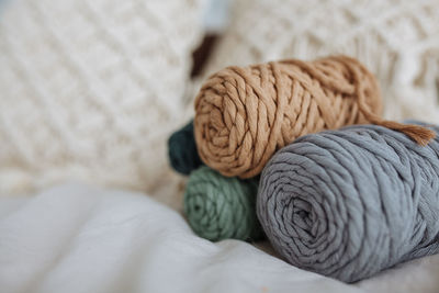 On a light background, a stack of cotton threads for macrame