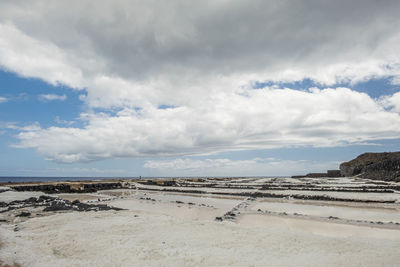 Scenic view of salt pans against sky