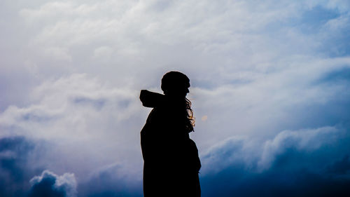 Low angle view of silhouette statue against sky
