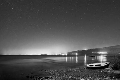 Scenic view of lake against sky at night