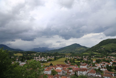 High angle view of town against cloudy sky