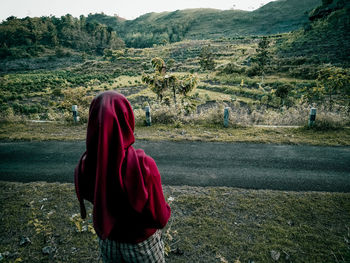 Rear view of woman on field