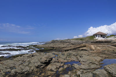 Rocks on beach against sky