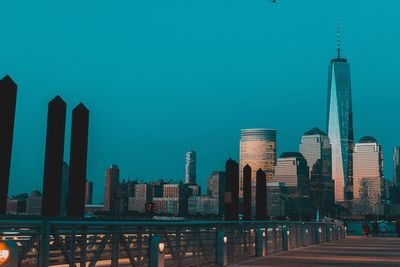 Modern buildings in city against clear blue sky
