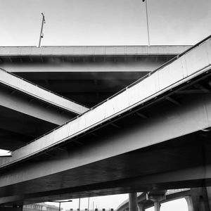 Low angle view of bridge against sky in city