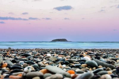 Rocks on beach against sky