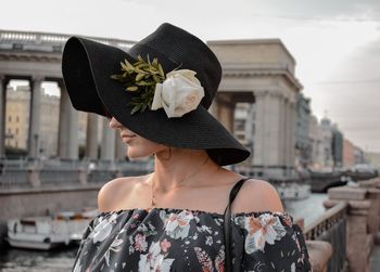 Young woman wearing hat in city