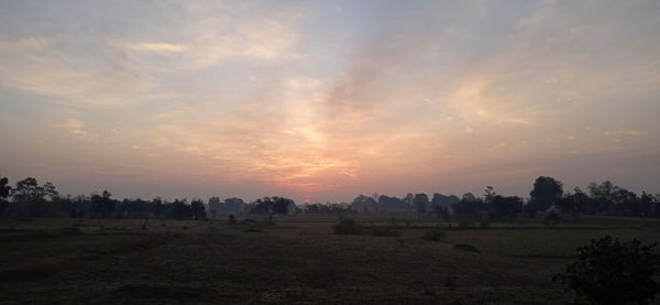 Scenic view of field against sky during sunset