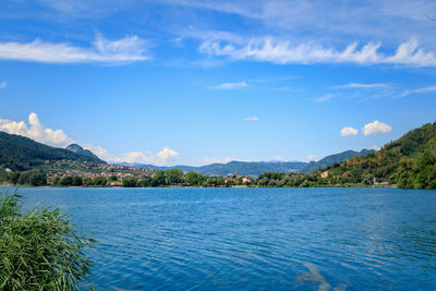 Scenic view of sea and mountains against sky