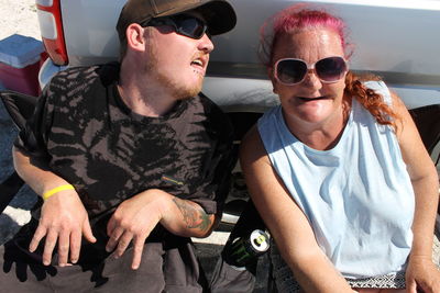 Portrait of friends wearing sunglasses outdoors