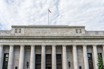 Low angle view of building against cloudy sky