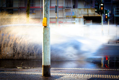 Crosswalk with car passing and splashing water 