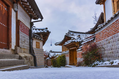 Low angle view of houses in city during winter