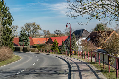 Empty road along buildings