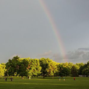 Scenic view of rainbow over landscape against sky