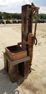 Old rusty metallic structure on land against sky